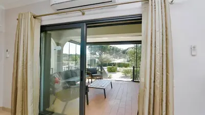 a living room with a sliding glass door at Villa Linda Rosa, CD 302 by Cleverdetails private pool, prime location in Vilamoura