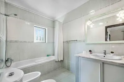 a bathroom with a sink and a toilet and a tub at Villa Agapito in Terras Novas