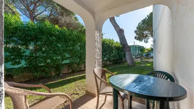 a glass table and chairs on a porch at Açoteias Studio w Pool by LovelyStay in Albufeira