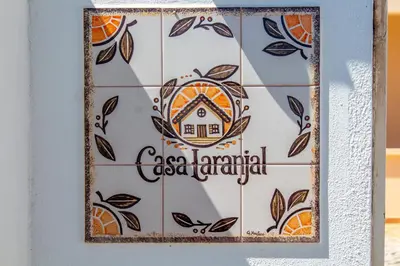 a patio with a table and an outdoor grill at Casa Laranjal in Albufeira