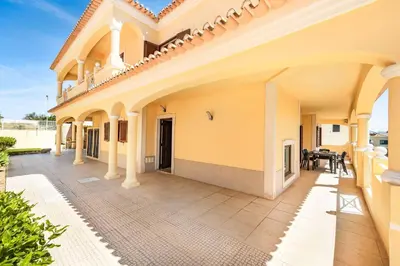 an external view of a house with a patio at Villa Alice Albufeira in Albufeira