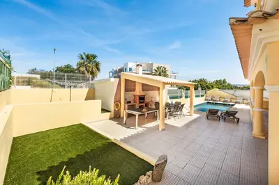 a house with a patio and a swimming pool at Villa Alice Albufeira in Albufeira