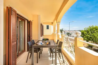 a balcony with a table and chairs on a balcony at Villa Alice Albufeira in Albufeira