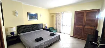 a bedroom with a bed with two bags on it at Centre View in Albufeira