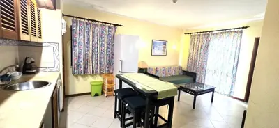 a kitchen with a refrigerator and a table in a kitchen at Centre View in Albufeira