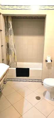 a bathroom with a tub and a toilet and a sink at Centre View in Albufeira