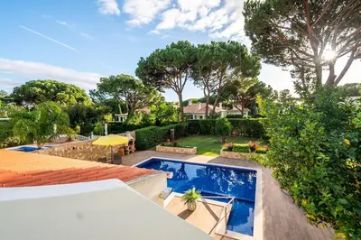 a house with a swimming pool in a yard at Villa Louanna in Vilamoura
