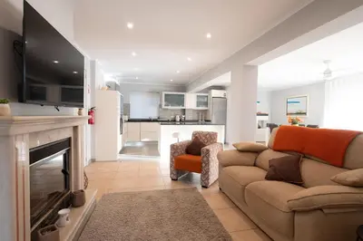a living room with a couch and a fireplace at Villa Louanna in Vilamoura