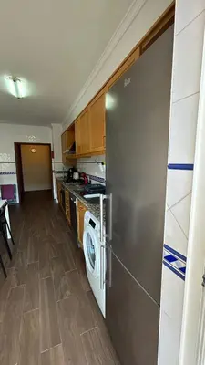 a kitchen with a refrigerator and a washing machine at Pórtico de Malpique in Albufeira