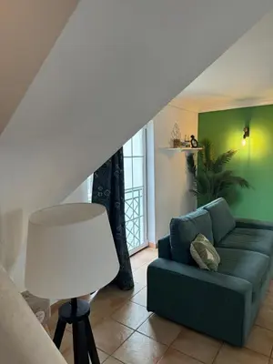 a living room with a couch and a lamp at Casa Estrelinha Vilamoura in Quarteira
