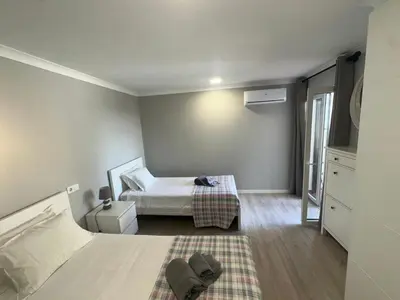 a bedroom with a bed and a mirror at Cliff Enchantment - Pool and Sea View in Albufeira in Albufeira