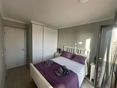 a bedroom with a large bed with purple sheets at Cliff Enchantment - Pool and Sea View in Albufeira in Albufeira