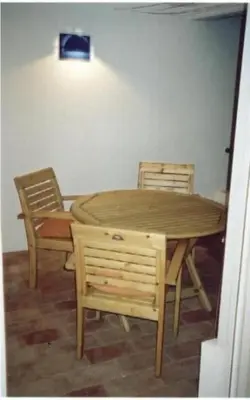 a wooden table and chairs in a room with a table and chairs at Windmill Hill Luxury Apartment in Albufeira