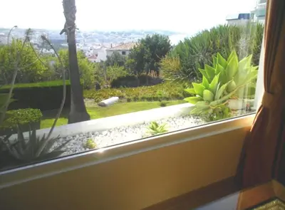 a window with a view of a garden at Windmill Hill Luxury Apartment in Albufeira