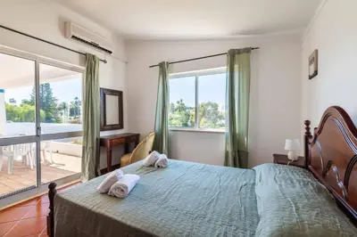 a bedroom with a large bed with towels on it at Villa Gabriella - Charming villa in great location close to everything you need in Guia