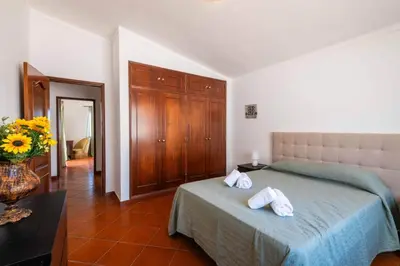 a bedroom with a bed with two towels on it at Villa Gabriella - Charming villa in great location close to everything you need in Guia