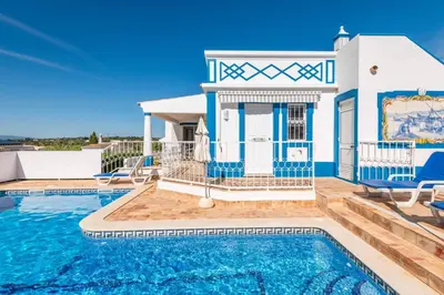 a villa with a swimming pool and a house at Villa Gabriella - Charming villa in great location close to everything you need in Guia
