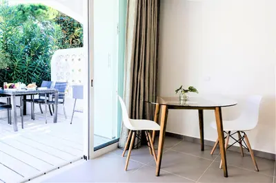 a dining room with a table and chairs on a patio at Vale do Lobo Apartment in Vale do Lobo