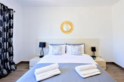 a bedroom with a large white bed with two pillows at Vale do Lobo Apartment in Vale do Lobo