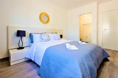 a bedroom with a large bed with two towels on it at Vale do Lobo Apartment in Vale do Lobo