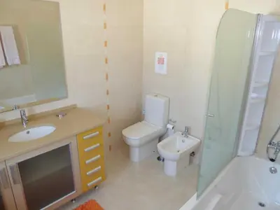 a bathroom with a toilet and a sink and a shower at Villa Hugo - bright modern walk to restaurants in Albufeira