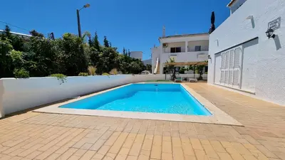 a swimming pool in front of a house at Villa Gabriel by Sunny Deluxe in Albufeira
