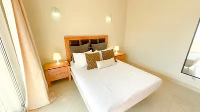 a bedroom with a bed with white sheets and pillows at Villa Gabriel by Sunny Deluxe in Albufeira