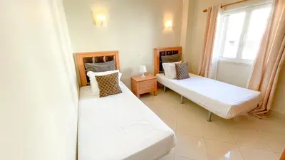 a bedroom with two beds and a window at Villa Gabriel by Sunny Deluxe in Albufeira