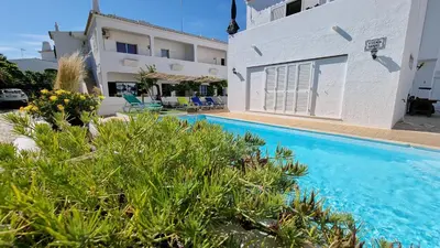 a villa with a swimming pool and a building at Villa Gabriel by Sunny Deluxe in Albufeira