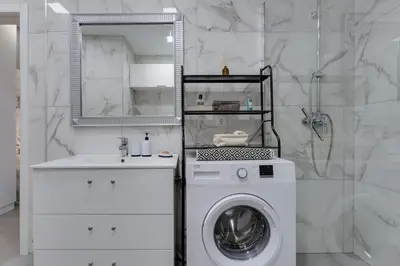 a white bathroom with a washing machine and a sink at BELLAVISTA STUDIO - Modern and Renovated near Fishermen's Beach in Albufeira