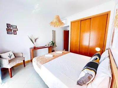 a bedroom with a large bed and a chair at Azure Heaven by BeCherish in Páteo