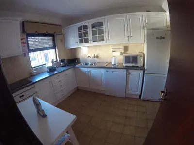 a kitchen with white cabinets and white appliances at Apartamento A11 - 800m da praia in Albufeira