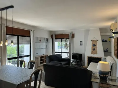 a living room with a couch and a chair and a television at Apartamento A11 - 800m da praia in Albufeira