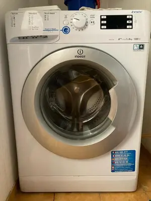 a white washing machine with its door open at Apartamento A11 - 800m da praia in Albufeira