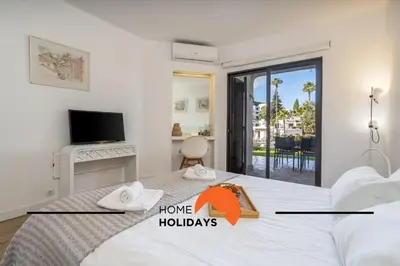 a bedroom with a large bed with a tv and a room with a bed sqor at #279 T2 Para Relaxar em Albufeira by Home Holidays in Albufeira