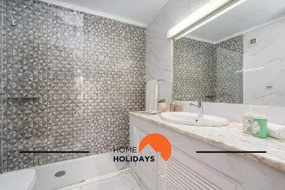 a bathroom with a shower and a sink and a mirror at #279 T2 Para Relaxar em Albufeira by Home Holidays in Albufeira