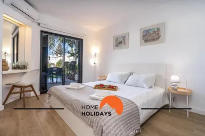 a bedroom with a bed with a tray of fruit on it at #279 T2 Para Relaxar em Albufeira by Home Holidays in Albufeira