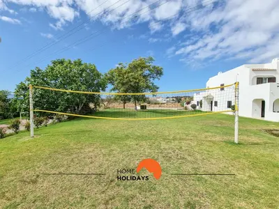 a volleyball net in a yard with a house at #279 T2 Para Relaxar em Albufeira by Home Holidays in Albufeira