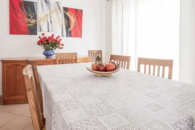 a dining room table with a bowl of fruit on it at Villa Cesaltina in Guia
