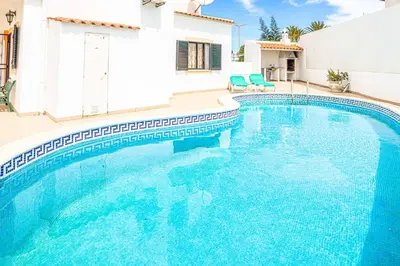 a swimming pool in front of a house at Villa Cesaltina in Guia