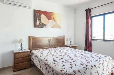 a bedroom with a bed and a painting on the wall at Villa Cesaltina in Guia