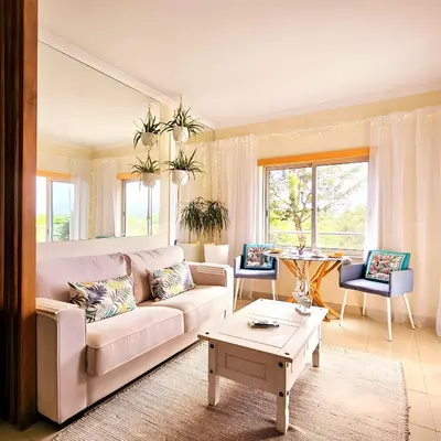 a living room with a couch and a table at T1 Albufeira Tranquilidade in Albufeira