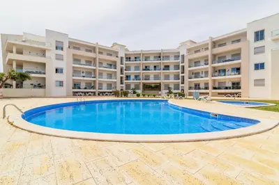 an image of a swimming pool in front of a building at T1 Albufeira Tranquilidade in Albufeira