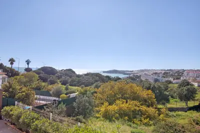 a view of a city from a hill with trees at Breeze Villa - Adults Only in Albufeira