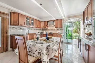 a kitchen with a table and chairs and a kitchen with at Villa Caty Catarina in Albufeira