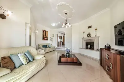 a living room with a couch and a fireplace at Villa Caty Catarina in Albufeira