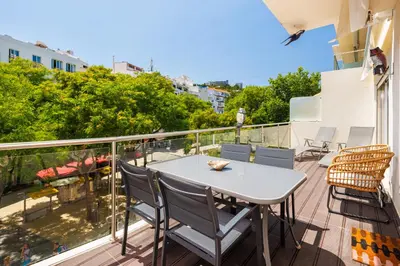 a balcony with a white table and chairs at Albufeira - Anna Town - NEW in Albufeira