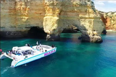 a boat in the water next to a cave at Albufeira - Anna Town - NEW in Albufeira