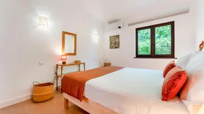 a bedroom with a large white bed and a window at Villa Casa Amendoeiras by LovelyStay in Albufeira