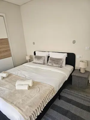 a bedroom with a large bed with towels on it at Oldtown Nightlife 2 in Faro